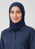 A navy blue hijab worn by a woman, complemented by a button-up shirt. The image features a logo.