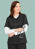 A women's black zip front crossover scrub top with a v-neckline. Includes a logo and features a model holding a stethoscope.