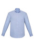 A light blue long sleeve button-up shirt featuring a pocket and a collar, with a logo on the fabric.