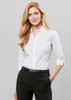A fitted women's white 3/4 sleeve button-up shirt with a pocket, styled with black pants.