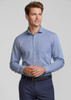A blue long sleeve button-up shirt with a chest pocket, worn by a smiling man. The shirt features a logo.