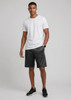 A model wearing black sports shorts and a plain white t-shirt, standing against a neutral background.