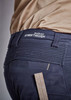 A close-up of navy shorts featuring a branded waistband and a ruler for measuring, highlighting the fabric's texture.