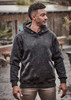 A unisex water-resistant hoodie in black, featuring a hood and front pockets, worn by a model outdoors.