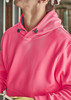 A unisex water-resistant hoodie in bright pink, featuring a hood and front pocket. It has a logo on the chest.