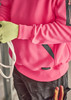 A unisex water-resistant hoodie in bright pink with black accents, worn by a person holding rope and wearing gloves.