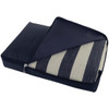A picnic rug with a black waterproof backing, folded and zipped inside a protective cover featuring striped fabric.
