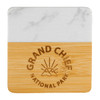 A marble and bamboo coaster featuring a logo and a smooth white marble top with a natural bamboo base.
