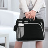 A black laptop bag with a mesh pocket, held by a person in business attire, featuring pens and a branding logo.