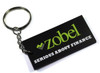 A black custom PVC keyring with a silver keychain, featuring green and white branding elements.
