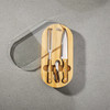 An oval bamboo knife set featuring a cheese knife, chef’s knife, and corkscrew, all with wooden handles.