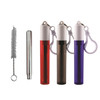 A set of four travel bottles in red, brown, and purple, with a cleaning brush and a keychain attachment.