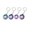 Four circular UV Checker keychains in green, purple, white, and black, each with a keyring attachment.