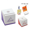 A pen holder with a clip in white and purple, featuring a logo, alongside clips and paper items.