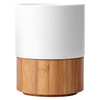 A ceramic mug with a white top and a natural bamboo base, featuring a simple, modern design. 