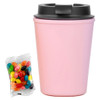 A drink bottle in pastel pink with a black lid, accompanied by a pack of colourful jelly beans.