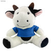 A plush cow toy with a black and white design, wearing a blue shirt and smiling. It has brown horns and soft features.