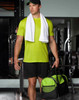 A sports travel bag in black and green, held by a person in a bright green athletic outfit with a towel draped around their neck.