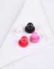 A set of four exchangeable buttons in white, black, red, and pink resting on a white chef uniform.