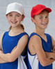 A red and a white brushed cotton cap, displayed on two smiling children wearing blue sports tops.