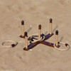A wooden backyard quoits set on sandy ground, featuring several pegs and rope rings. It has a natural wood finish.