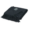 A black Merino blanket featuring fringed edges and a small logo patch.