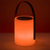 A glowing orange speaker lamp with a handle, featuring a smooth cylindrical design and a metallic top.