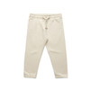 Cream-coloured kids' track pants featuring an elasticated waistband and side pockets. The pants have a logo detail.