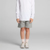 Kids stadium shorts in grey, featuring an elastic waistband and a logo, styled with a long-sleeve white top and sneakers.