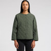 A quilted green jacket featuring a round neckline and button closures, worn by a model.