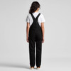 Black canvas overalls worn with a white T-shirt, featuring adjustable straps and a logo on the back.