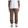 Brown track pants with an elasticated waistband, featuring a relaxed fit and a logo on the side, paired with grey sneakers.