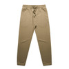 A pair of beige track pants with an elastic waistband and cuffs, featuring a drawstring and a logo.