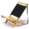 A wooden beach chair with a black fabric seat and backrest, featuring a strap for easy carrying.