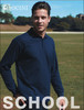 A navy long sleeve polo shirt on a model standing in a grassy area. The shirt features a logo on the chest.