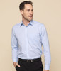A button-up shirt in light blue with long sleeves and a chest pocket, featuring a branding logo.