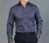 A button-up shirt in dark grey with long sleeves and a fitted design, featuring a logo on the chest.