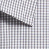 A button-up shirt featuring a grey and white gingham pattern with a detailed collar. It has branding visible.