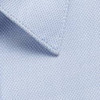A light blue button-up shirt fabric close-up, featuring textured weave and neat collar detail.