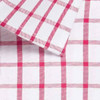 A button-up shirt featuring a white fabric with a pink check pattern. The collar is also visible in the image.