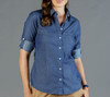 A blue chambray button-up shirt with rolled cuffs and a chest pocket, featuring a subtle pattern.