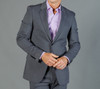 A grey jacket is displayed, featuring structured lapels and a slim fit, worn over a light purple shirt.