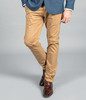 A pair of beige chino pants, featuring a slim fit, worn with a blue blazer and brown dress shoes.
