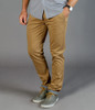 A pair of tan chinos featured with a casual grey shirt and grey shoes, displaying a stylish, fitted design.