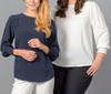 A navy blue top with shirred cuffs alongside a white top, both with a loose fit and round necklines.