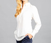 A white half-placket shirt featuring long sleeves and a collar, styled with a casual look against a grey background.