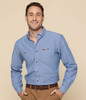 A blue work shirt with a button-up design and a pocket, featuring a branding logo on the chest.