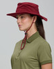 A burgundy bucket hat with a chin strap displayed on a person wearing a green polo shirt. Features a logo.