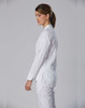 A white chef jacket designed for women, featuring long sleeves and a simple, elegant design.