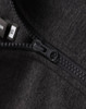 A close-up of a black half-zip collar fleecy jumper featuring a zipper and tags.